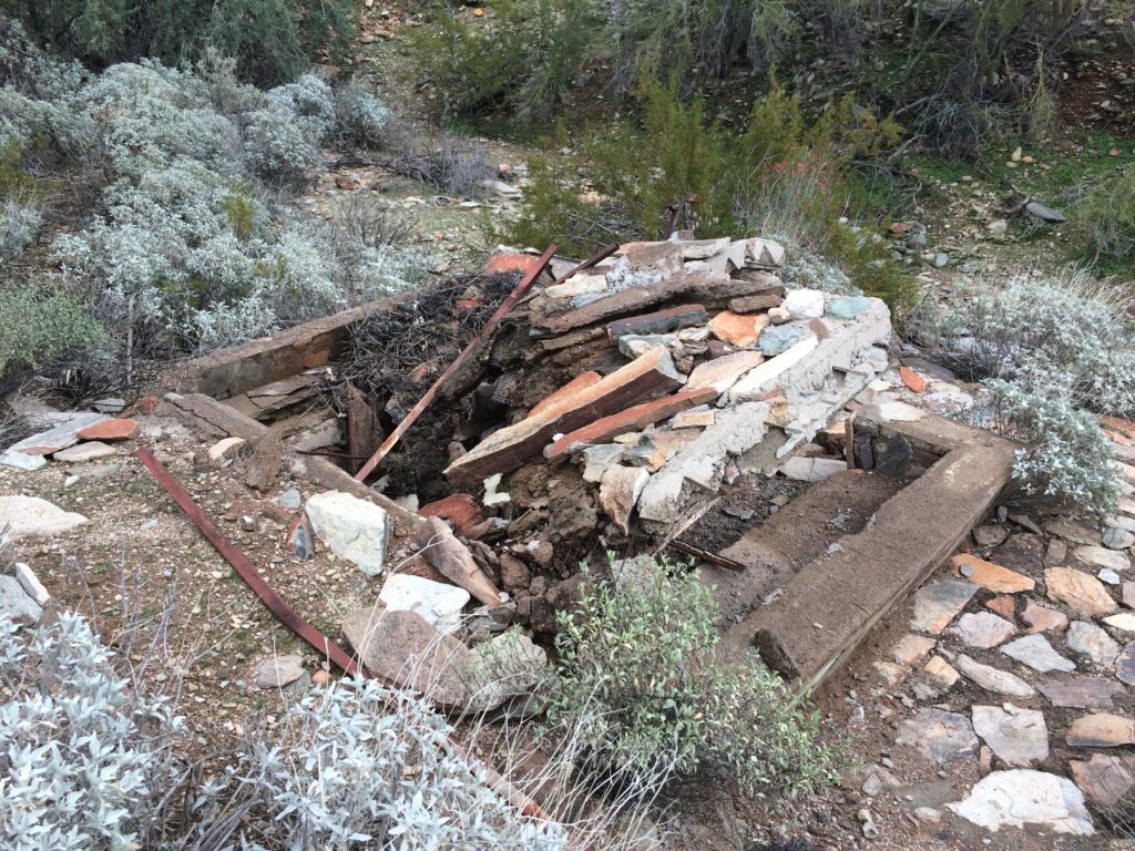 A fallen shelter slowly absorbing into the desert.